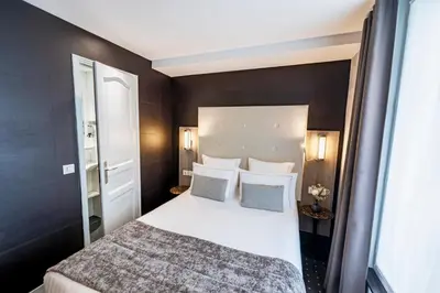 Un ou plusieurs lits dans un hébergement de l'établissement Hotel de la Paix Tour Eiffel