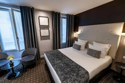 Un ou plusieurs lits dans un hébergement de l'établissement Hotel de la Paix Tour Eiffel