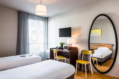 Un ou plusieurs lits dans un hébergement de l'établissement Aparthotel Adagio Access Paris Vanves - Porte de Châtillon