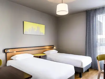 Un ou plusieurs lits dans un hébergement de l'établissement Aparthotel Adagio Access Paris Vanves - Porte de Châtillon