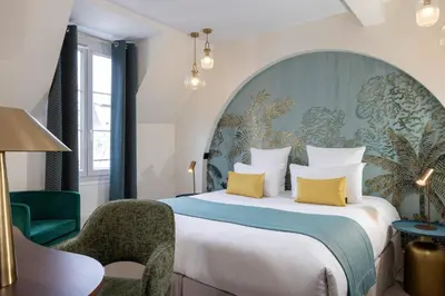Un ou plusieurs lits dans un hébergement de l'établissement Hotel Elysées Bassano