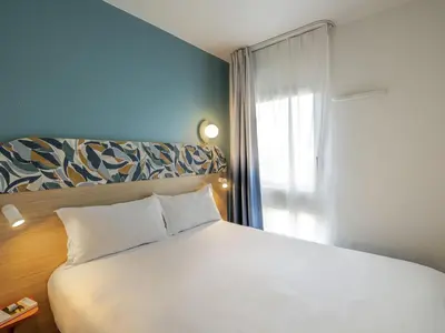 Un ou plusieurs lits dans un hébergement de l'établissement Aparthotel Adagio Access Paris La Villette