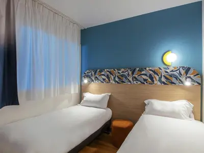 Un ou plusieurs lits dans un hébergement de l'établissement Aparthotel Adagio Access Paris La Villette