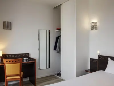 Un ou plusieurs lits dans un hébergement de l'établissement Aparthotel Adagio Access Paris Philippe Auguste