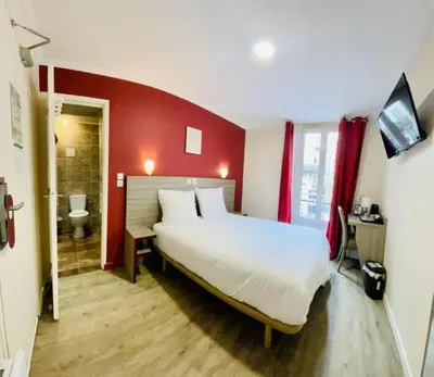 Un ou plusieurs lits dans un hébergement de l'établissement Hipotel Paris Gambetta République