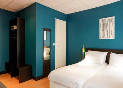 Un ou plusieurs lits dans un hébergement de l'établissement Hotel Daval