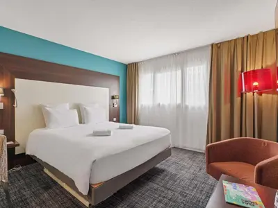 Un ou plusieurs lits dans un hébergement de l'établissement Mercure Paris Porte d'Orleans