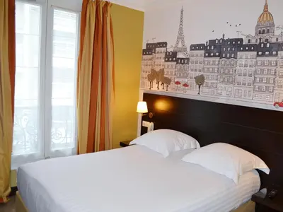 Un ou plusieurs lits dans un hébergement de l'établissement Hôtel de l'Exposition - Tour Eiffel