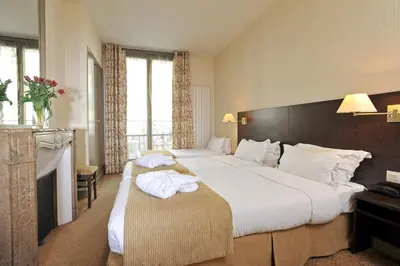 Un ou plusieurs lits dans un hébergement de l'établissement Hôtel Vaneau Saint Germain