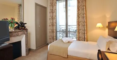 Un ou plusieurs lits dans un hébergement de l'établissement Hôtel Vaneau Saint Germain