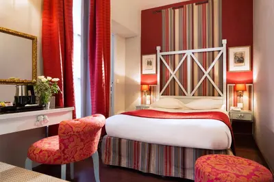 Un ou plusieurs lits dans un hébergement de l'établissement Hotel Louvre Bons Enfants