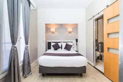 Un ou plusieurs lits dans un hébergement de l'établissement HOTEL DE PARIS MONTPARNASSE