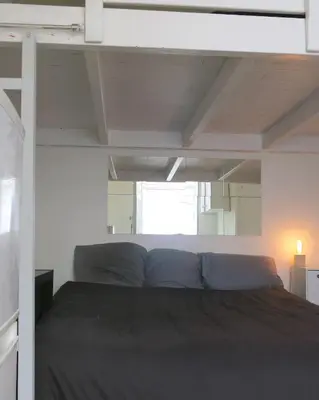 Un ou plusieurs lits dans un hébergement de l'établissement Mini Loft Del Sarte CityCosy