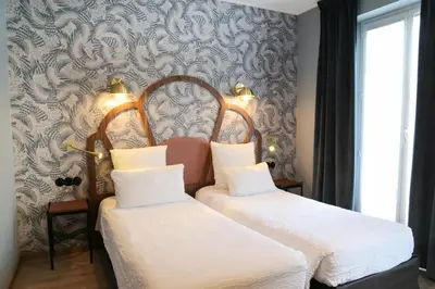 Un ou plusieurs lits dans un hébergement de l'établissement Hotel André Latin