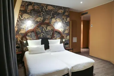 Un ou plusieurs lits dans un hébergement de l'établissement Hotel André Latin