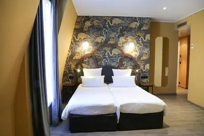 Un ou plusieurs lits dans un hébergement de l'établissement Hotel André Latin