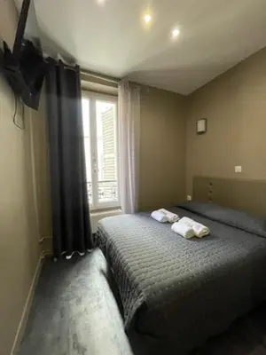 Un ou plusieurs lits dans un hébergement de l'établissement Hôtel de l'Aveyron