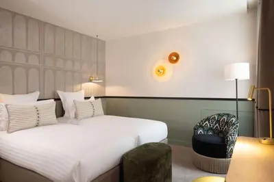 Un ou plusieurs lits dans un hébergement de l'établissement Hotel Grand Coeur Latin
