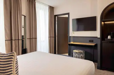 Un ou plusieurs lits dans un hébergement de l'établissement Hotel Grand Coeur Latin