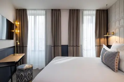 Un ou plusieurs lits dans un hébergement de l'établissement Hotel Grand Coeur Latin