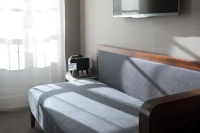 Un ou plusieurs lits dans un hébergement de l'établissement Hotel Saint Dominique