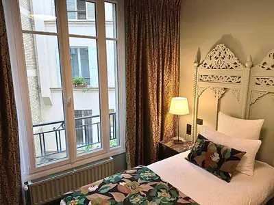 Un ou plusieurs lits dans un hébergement de l'établissement Hotel Villa Nicolo - Tour Eiffel