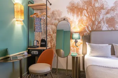 Un ou plusieurs lits dans un hébergement de l'établissement Hotel Avalon Paris
