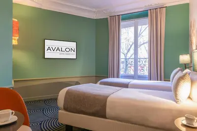 Un ou plusieurs lits dans un hébergement de l'établissement Hotel Avalon Paris