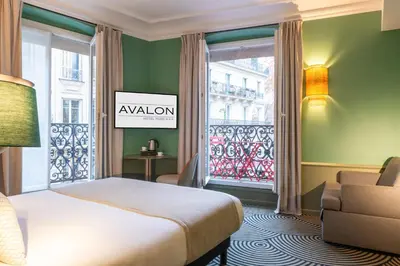 Un ou plusieurs lits dans un hébergement de l'établissement Hotel Avalon Paris