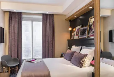 Un ou plusieurs lits dans un hébergement de l'établissement Hotel Ducs de Bourgogne
