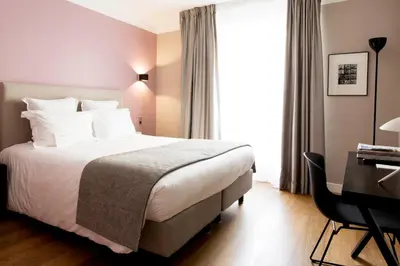 Un ou plusieurs lits dans un hébergement de l'établissement Hôtel Mathis Elysées