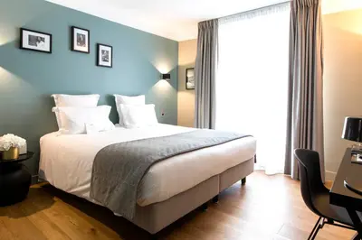 Un ou plusieurs lits dans un hébergement de l'établissement Hôtel Mathis Elysées