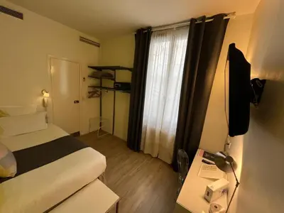 Un ou plusieurs lits dans un hébergement de l'établissement Hôtel Marais de Launay