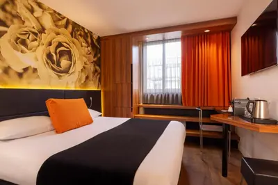 Un ou plusieurs lits dans un hébergement de l'établissement Hôtel Elixir