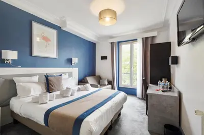 Un ou plusieurs lits dans un hébergement de l'établissement Grand Hôtel Des Gobelins