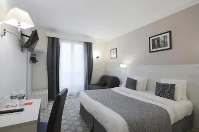 Un ou plusieurs lits dans un hébergement de l'établissement Grand Hôtel Des Gobelins