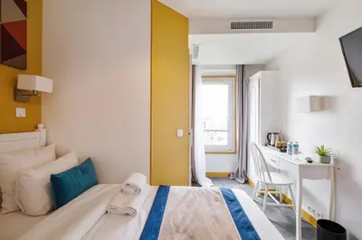 Un ou plusieurs lits dans un hébergement de l'établissement Grand Hôtel Des Gobelins