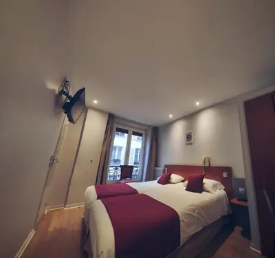 Un ou plusieurs lits dans un hébergement de l'établissement Little Hôtel