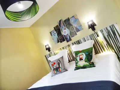 Un ou plusieurs lits dans un hébergement de l'établissement Le Pavillon Hotel