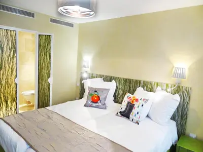 Un ou plusieurs lits dans un hébergement de l'établissement Le Pavillon Hotel