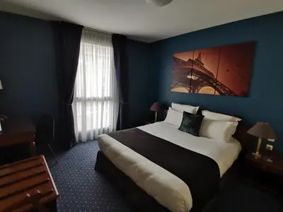 Un ou plusieurs lits dans un hébergement de l'établissement Amiral Hôtel