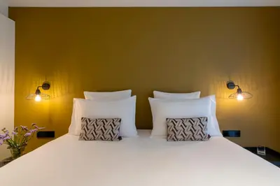 Un ou plusieurs lits dans un hébergement de l'établissement 9Hotel Opera