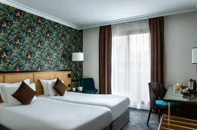 Un ou plusieurs lits dans un hébergement de l'établissement Hôtel Mercure Paris Boulogne Pont de Saint Cloud