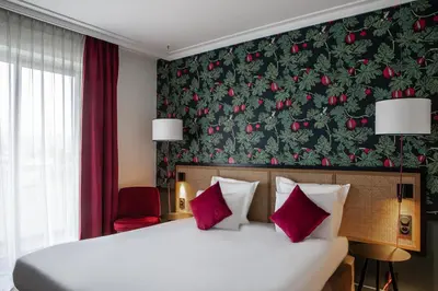 Un ou plusieurs lits dans un hébergement de l'établissement Hôtel Mercure Paris Boulogne Pont de Saint Cloud