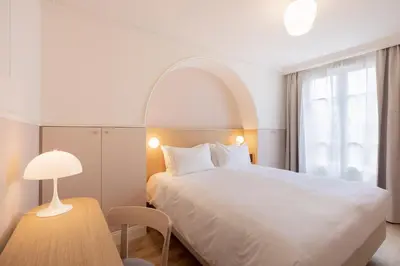 Un ou plusieurs lits dans un hébergement de l'établissement Hôtel Oratio