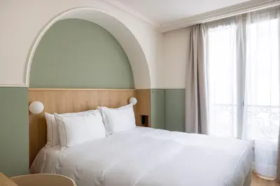 Un ou plusieurs lits dans un hébergement de l'établissement Hôtel Oratio