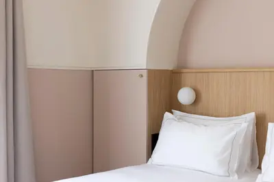 Un ou plusieurs lits dans un hébergement de l'établissement Hôtel Oratio