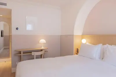 Un ou plusieurs lits dans un hébergement de l'établissement Hôtel Oratio