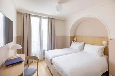 Un ou plusieurs lits dans un hébergement de l'établissement Hôtel Oratio