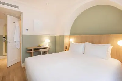 Un ou plusieurs lits dans un hébergement de l'établissement Hôtel Oratio